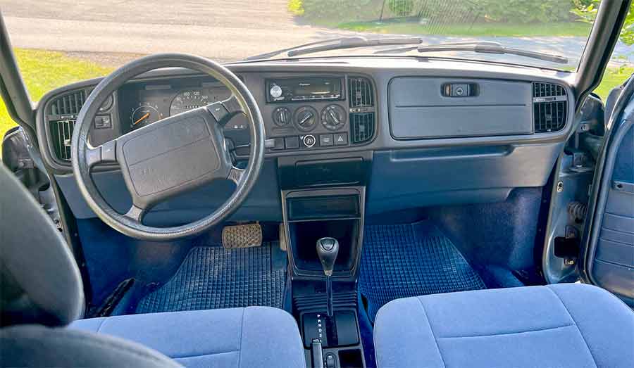 The interior of this 1993 Saab 900 Griffin is exceptionally well-preserved, featuring original blue upholstery and a pristine dashboard. Equipped with a 3-speed automatic transmission, this classic car has been meticulously maintained and offers a comfortable and nostalgic driving experience. Perfect for any Saab enthusiast looking for a blend of vintage charm and reliability.