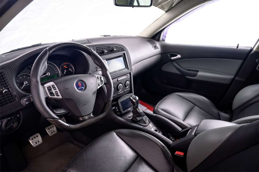 Interior view of the 2008 Saab 9-3 Aero SportSedan, featuring luxurious leather seats, carbon fiber accents, and Hirsch Performance details, blending comfort with a sporty, high-end aesthetic.