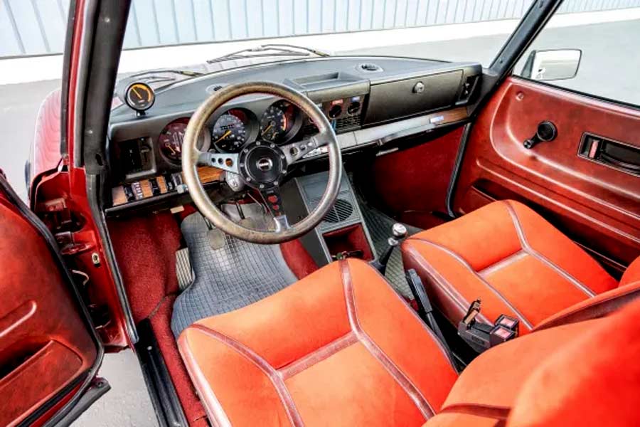 Inside the 1978 Saab 99 Turbo: A Luxurious Red Upholstery with Woodgrain Accents, Embodying Elegance and Scandinavian Craftsmanship