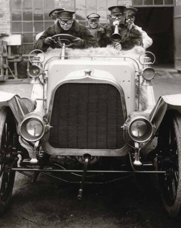 Automobile with five passengers outside Gustav Ericsson's Automobile Factory. The driver is probably Gustaf L M Ericsson himself.