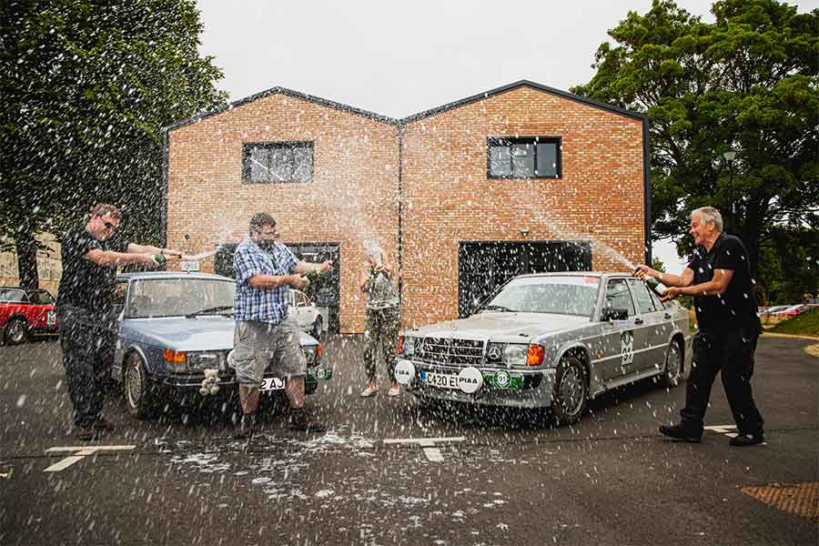 "Cheers to a well-deserved win! Alistair Leckie and Matt Outhwaite pop the champagne in celebration of their first victory, after pushing hard in their SAAB 900 Turbo during the rally.