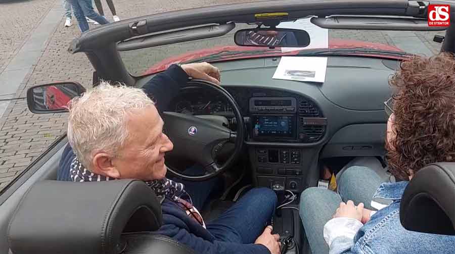 Eduard Mesritz and his daughter Jocelyne share a joyful moment inside their beloved red Saab during the Lions IJsselvallei Classics rally, celebrating their emotional journey and treasured memories.