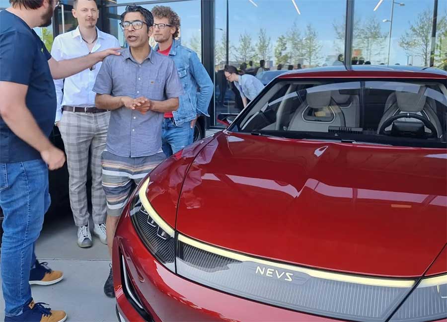 Hirash Razaghi, the lead exterior designer of the NEVS Emily GT, discussing the car’s unique design elements and development journey during an exclusive event.