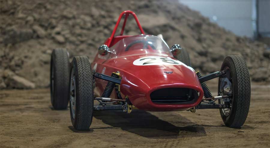 A close-up view of the Saab Quantum IV, a classic red open-wheel race car. The front end is prominently featured, showing off the vehicle's sleek design and racing number. (Photo by Lauritz A. Heskje)