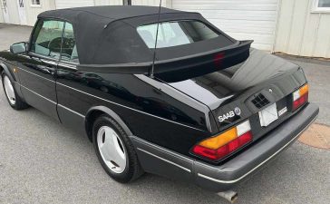 Rear view of the rare 1988 Saab 900 Turbo Convertible SIS Edition, showcasing its sleek black exterior and classic design, currently up for auction on Bring A Trailer.