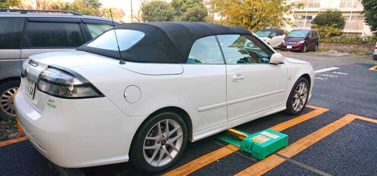 A Saab 9-3 Convertibl belonging to Mr. Ikuo who is neatly parked on one of the typical parking lots in Tokyo