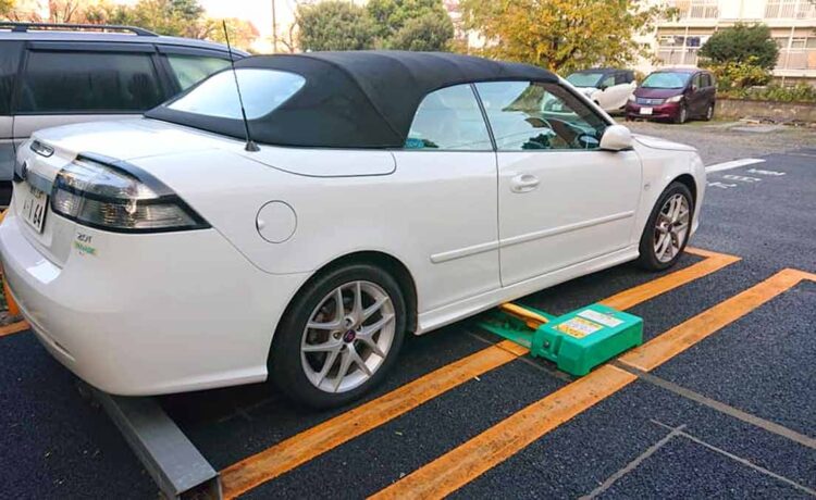 A Saab 9-3 Convertibl belonging to Mr. Ikuo who is neatly parked on one of the typical parking lots in Tokyo