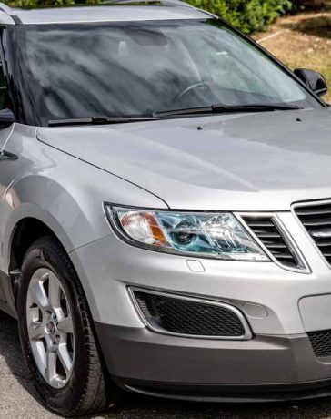 A pristine 2011 Saab 9-4X Premium in Diamond Silver Metallic, showcasing its elegance and rare low mileage of just 15,000.