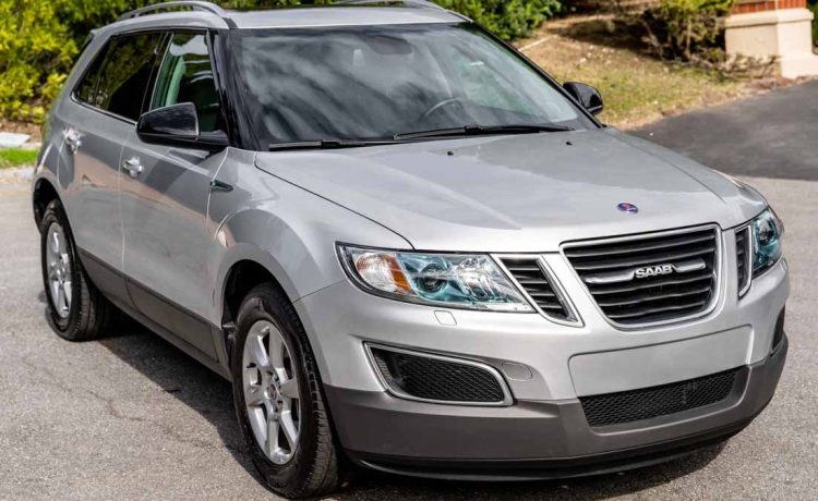 A pristine 2011 Saab 9-4X Premium in Diamond Silver Metallic, showcasing its elegance and rare low mileage of just 15,000.