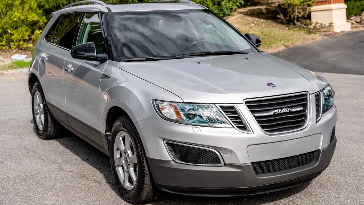 A pristine 2011 Saab 9-4X Premium in Diamond Silver Metallic, showcasing its elegance and rare low mileage of just 15,000.