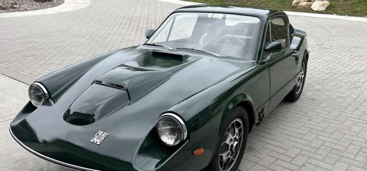 A meticulously restored 1969 Saab Sonett II V4 in a striking green, featuring classic 'soccer-ball' alloy wheels and a distinctive clamshell hood.