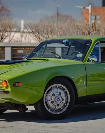 1970 SAAB Sonett III in green color with a sleek, sporty design, parked on a sunny day