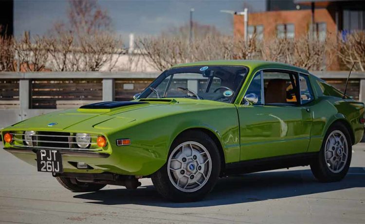 1970 SAAB Sonett III in green color with a sleek, sporty design, parked on a sunny day