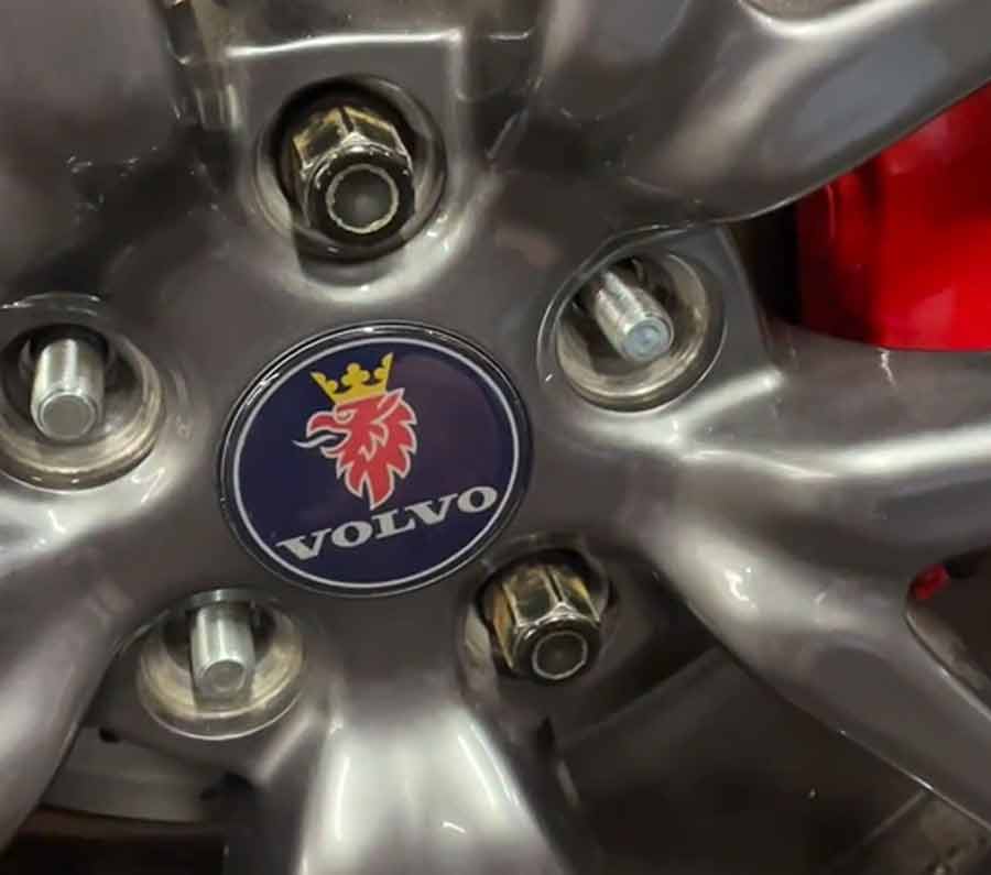 A unique blend of Swedish automotive heritage: the Saab griffin emblem adorns a Volvo wheel, symbolizing a seamless union between two iconic car brands.