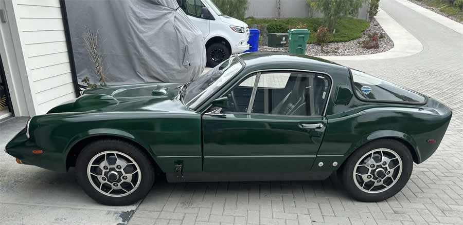 Side view of the classic 1969 Saab Sonett II V4, showcasing its sleek design and vibrant green finish.