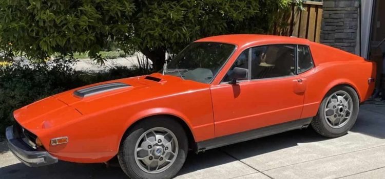 A classic 1973 Saab Sonett III in original burnt orange, showcasing its distinctive 'soccer ball' wheels and timeless design.