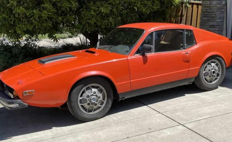 A classic 1973 Saab Sonett III in original burnt orange, showcasing its distinctive 'soccer ball' wheels and timeless design.