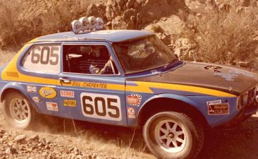 Bill Carpenter’s iconic Saab 99, captured during the 1980 Parker 400 race, showcases the modifications made for off-road racing, including its lifted front motor mount and protruding carburetors.