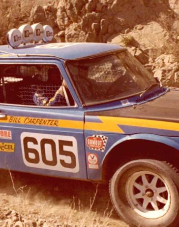 Bill Carpenter’s iconic Saab 99, captured during the 1980 Parker 400 race, showcases the modifications made for off-road racing, including its lifted front motor mount and protruding carburetors.