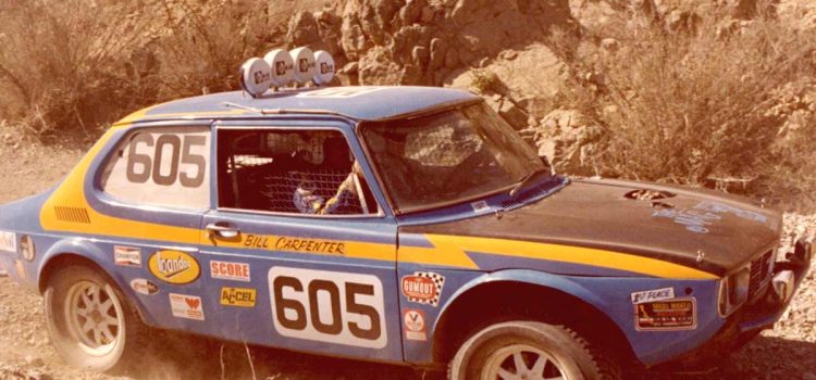 Bill Carpenter’s iconic Saab 99, captured during the 1980 Parker 400 race, showcases the modifications made for off-road racing, including its lifted front motor mount and protruding carburetors.