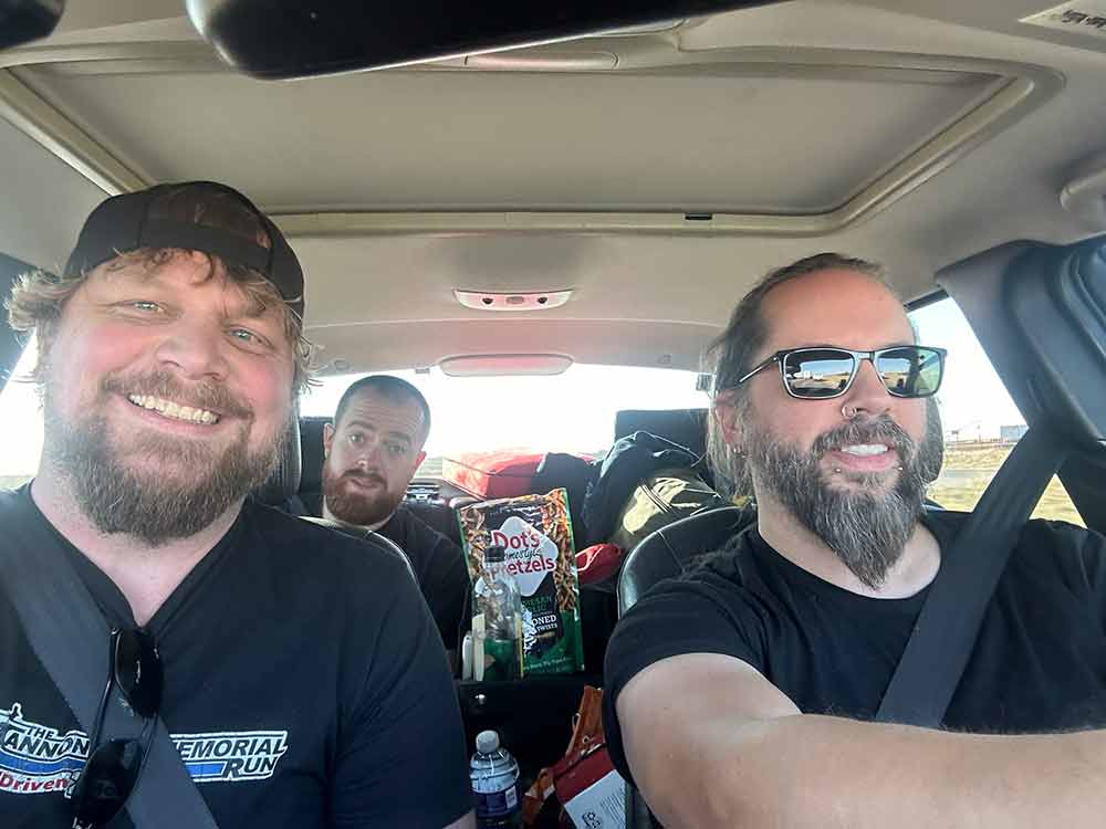 From left to right: Nik Krueger, Wes Vigh, and Christopher Michaels— the record-breaking team behind the historic Cannonball Run in a Saab 9-5 Aero.