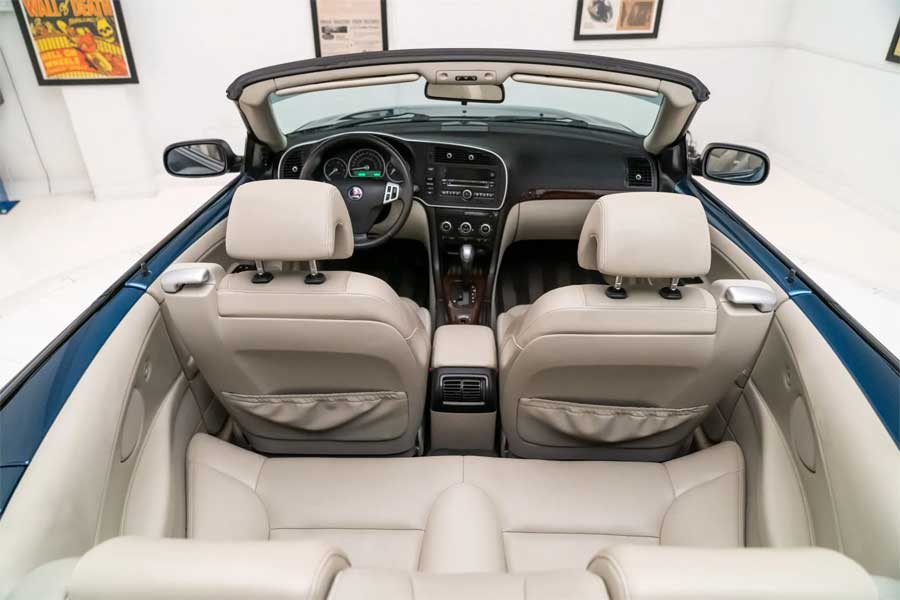 The Parchment leather upholstery looks immaculate, adding a touch of luxury to the cabin.  The overall presentation of the interior reflects the car's meticulous care and thoughtful design, making it a standout choice for enthusiasts and collectors alike.