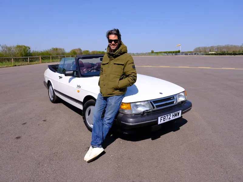 Elvis stands proudly in front of the fully restored Saab 900, ready to find its new owner.