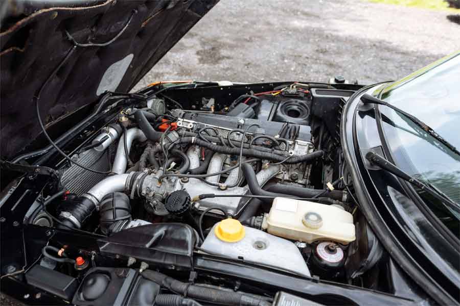 The well-maintained engine bay of the 1990 Saab 900 T16S FPT Convertible, showcasing its 1,985cc 16V turbocharged engine delivering 175bhp, paired with a 5-speed manual gearbox.