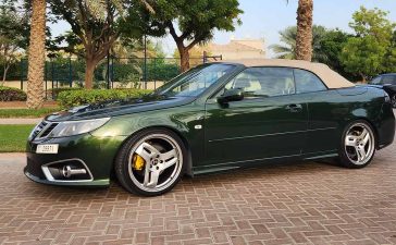 A beautifully customized green Saab 9-3 Convertible, meticulously upgraded by Dušan Marjanović in Dubai, showcasing unique design elements and Hirsch Performance alloy wheels.