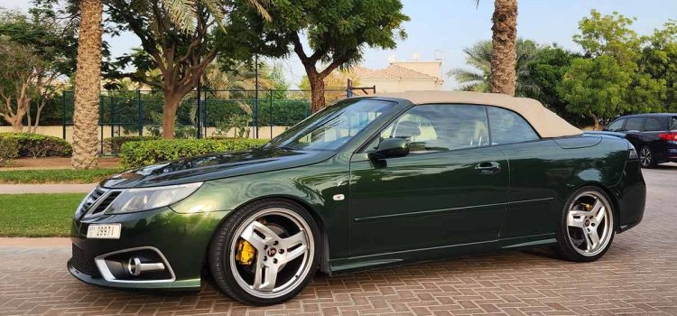 A beautifully customized green Saab 9-3 Convertible, meticulously upgraded by Dušan Marjanović in Dubai, showcasing unique design elements and Hirsch Performance alloy wheels.