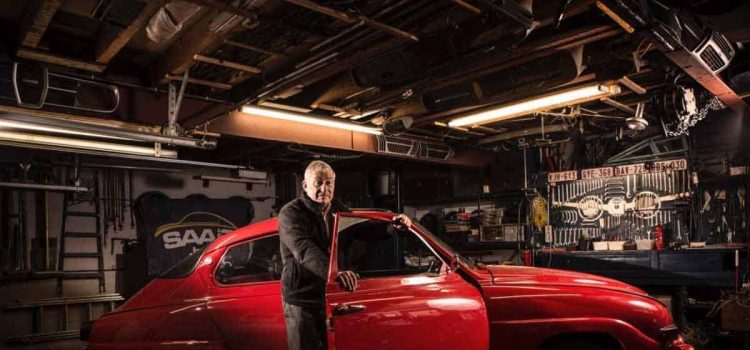 A timeless tribute: Hans Wagemans, a beacon of the Saab community, stands beside his Saab 96, a symbol of enduring passion. This image captures a moment of pride and joy, as Hans leans on his classic car, his smile as genuine as his love for Saab. Together, they represent a legacy of automotive enthusiasm and a bond between man and machine forged in dedication and love.