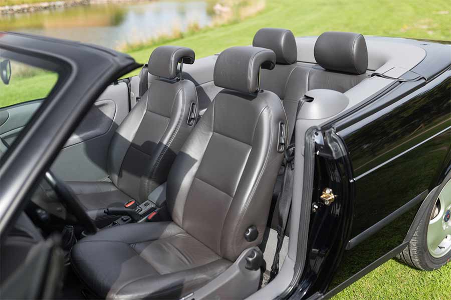 The leather interior of the 1998 Saab 9-3 SE 2.0T Convertible is in immaculate condition, with seats that show no signs of wear, reflecting the car's careful preservation and minimal use over the past 25 years.