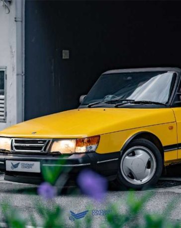 Experience the thrill of driving in style with the Lynx Yellow SAAB 900 Convertible.