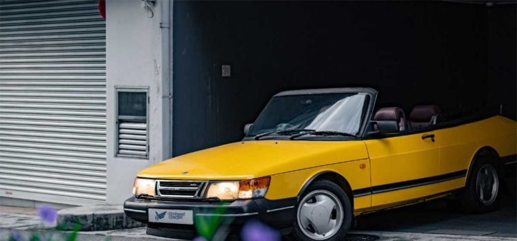 Experience the thrill of driving in style with the Lynx Yellow SAAB 900 Convertible.