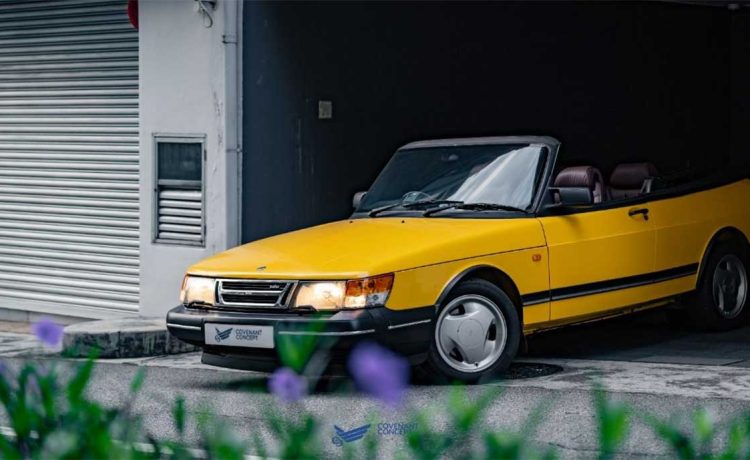 Experience the thrill of driving in style with the Lynx Yellow SAAB 900 Convertible.