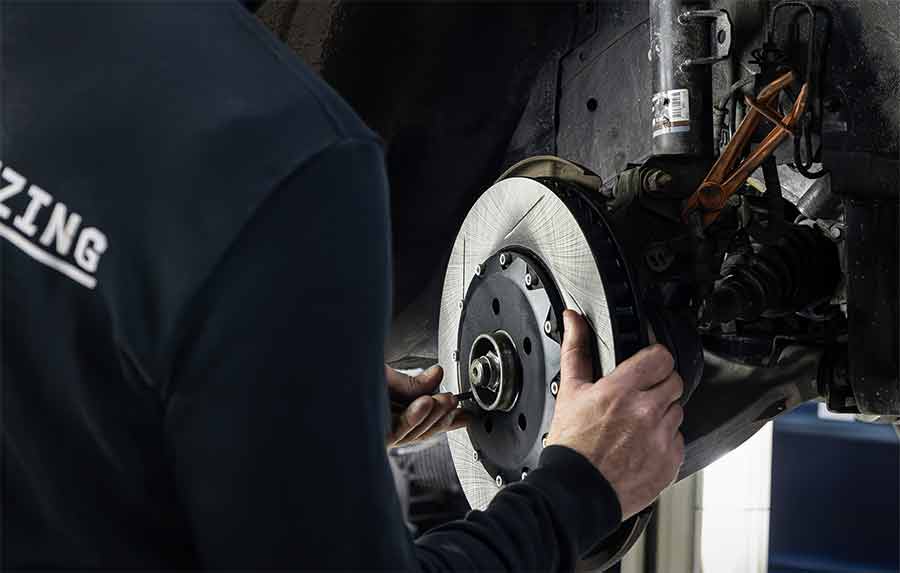 Precision installation of Maptun’s XT Series 6-piston brake upgrade, ensuring the Saab 9-3 handles its newfound power with confidence and control.