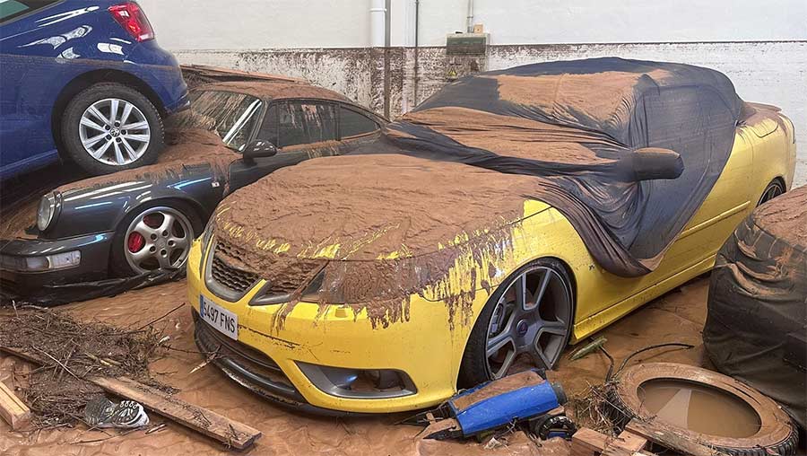 Saab’s resilience buried in mud: A yellow Saab 9-3 Convertible, part of Paco Ferris' cherished collection, lies damaged but not forgotten after Valencia’s catastrophic floods