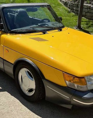 A stunning 1991 Saab 900 SE Turbo Convertible in Monte Carlo Yellow, meticulously maintained and currently up for auction on Bring-a-Trailer.