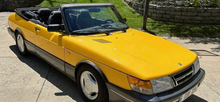 A stunning 1991 Saab 900 SE Turbo Convertible in Monte Carlo Yellow, meticulously maintained and currently up for auction on Bring-a-Trailer.