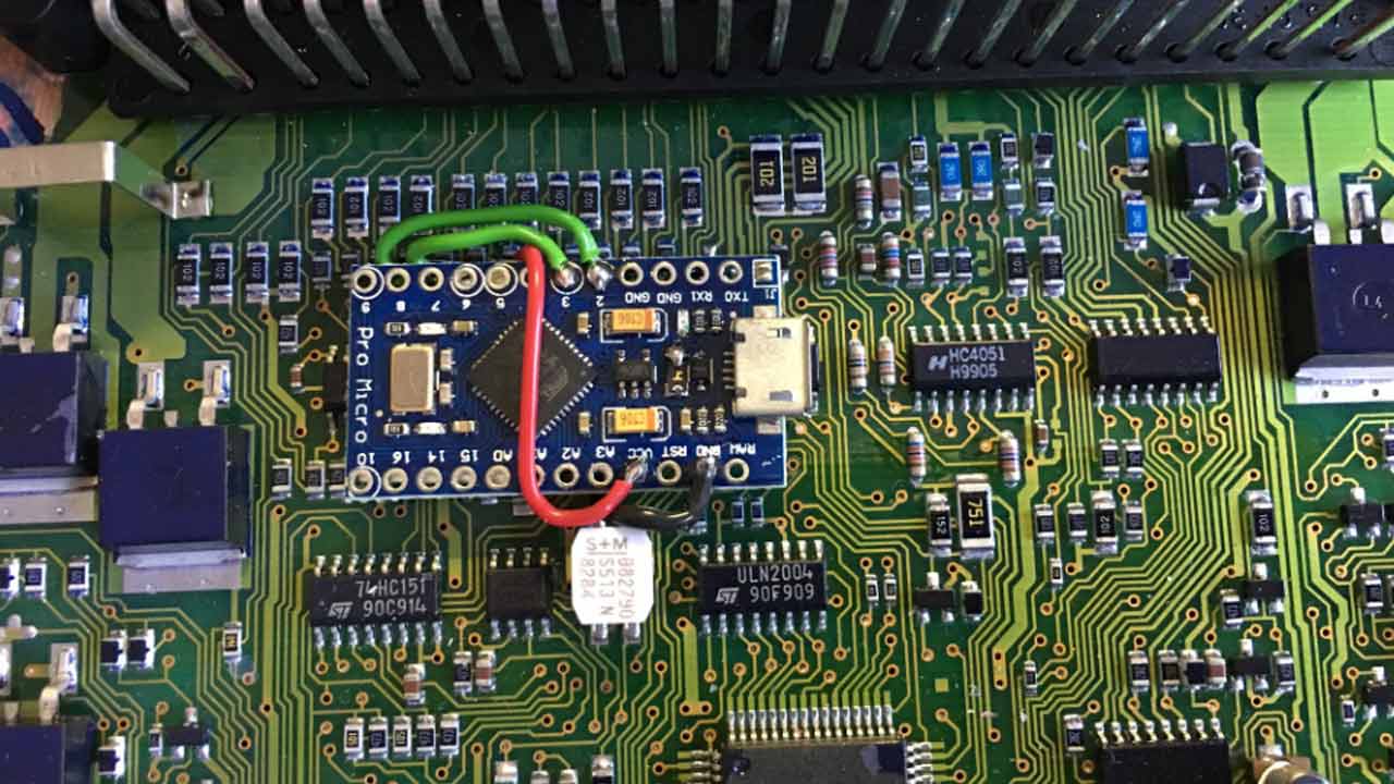 Installation of the Pro Micro in the Saab 9-5 DICE Module: The microcontroller board is securely attached atop the multiplexer using double-sided tape, simplifying the process with direct connections for power and signals.