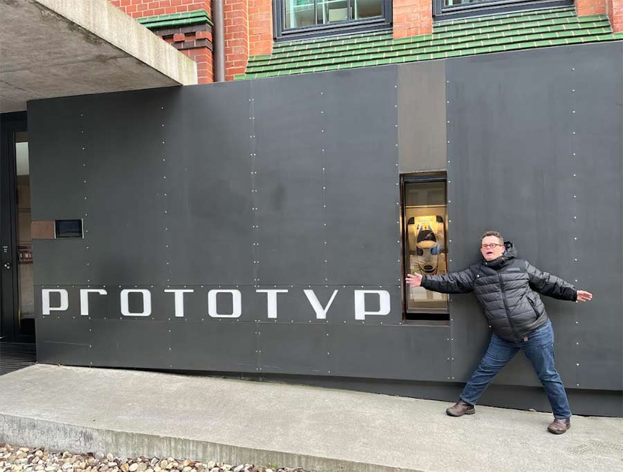 One of Melvin Könings' travel companions posing outside the Prototyp car museum in Hamburg, renowned for its remarkable collection of rare and historic vehicles.