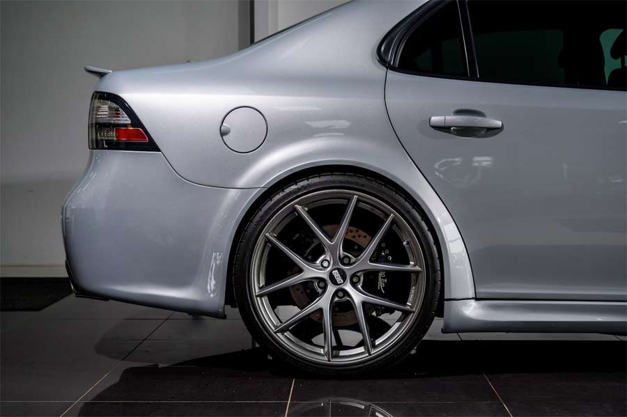  Close-up view of the rear section of the 2008 Saab 9-3 Aero SportSedan, featuring 20-inch BBS wheels and extended wheel arches. These modifications not only enhance the car's aggressive stance but also emphasize its sporty and high-performance character.