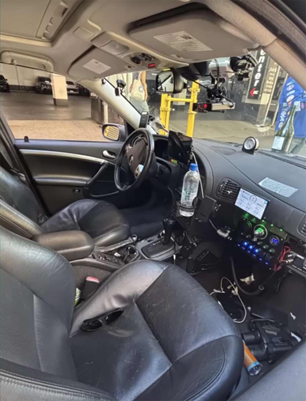 The modified Saab 9-5 Aero interior, showcasing the driver's seat and co-driver's spotter station—equipped with cutting-edge electronics for navigation, radar detection, and mission control.