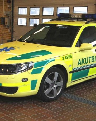 Saab 9-5: From Law Enforcement to Lifesaver – A captivating transformation captured as the Saab 9-5 dons its vibrant 'Ambulance Yellow' livery, transitioning from a specialized police cruiser to a life-saving medical vehicle.