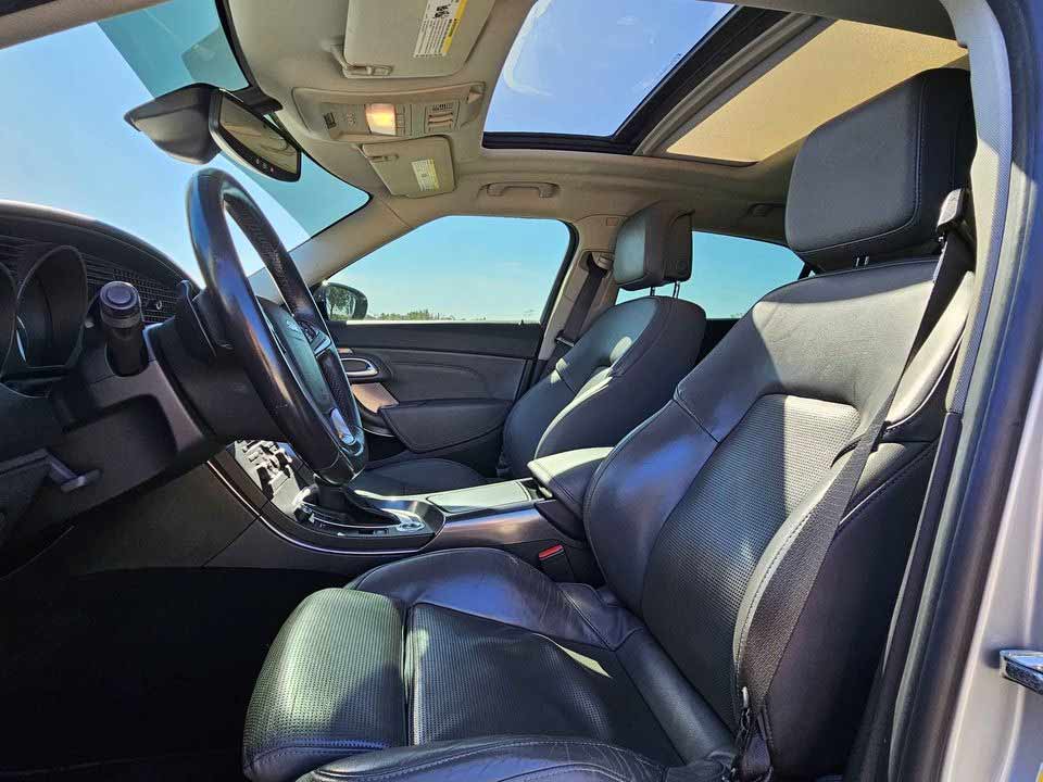 The cockpit-inspired interior of the 2011 Saab 9-5ng AERO TURBO6, featuring a unique altimeter-style speedometer, luxurious leather heated seats, and state-of-the-art connectivity options.