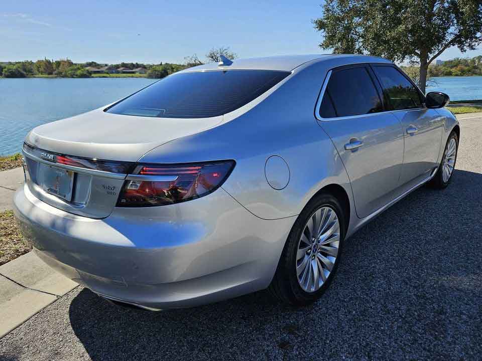  Immaculate rear perspective of the 2011 Saab 9-5ng AERO TURBO6, showcasing its fully functional LED bar and a pristine chassis free from any scratches or damage, reflecting meticulous care and maintenance."