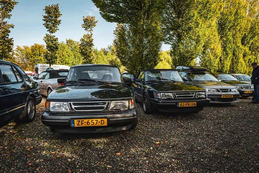 A lineup of classic Saab 900 Turbo models at the 65th anniversary gathering.