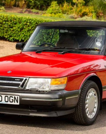 Pristine 1990 Saab 900 Turbo 16 Convertible in radiant red, a classic beauty that recently fetched £33,750 at auction, showcasing its impeccable preservation and low mileage.