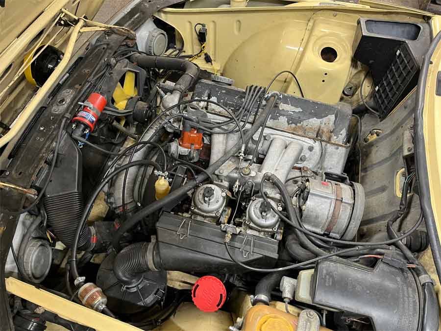 Under the hood of the 1981 Saab 900 GLS: a well-maintained twin carburettor engine that exemplifies Swedish engineering and the car’s dependable performance.