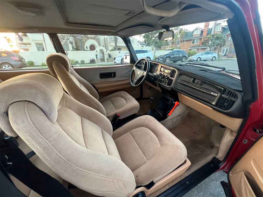 Step into the impeccably preserved interior of the Saab 900, where timeless design meets pristine condition, creating a truly remarkable driving experience